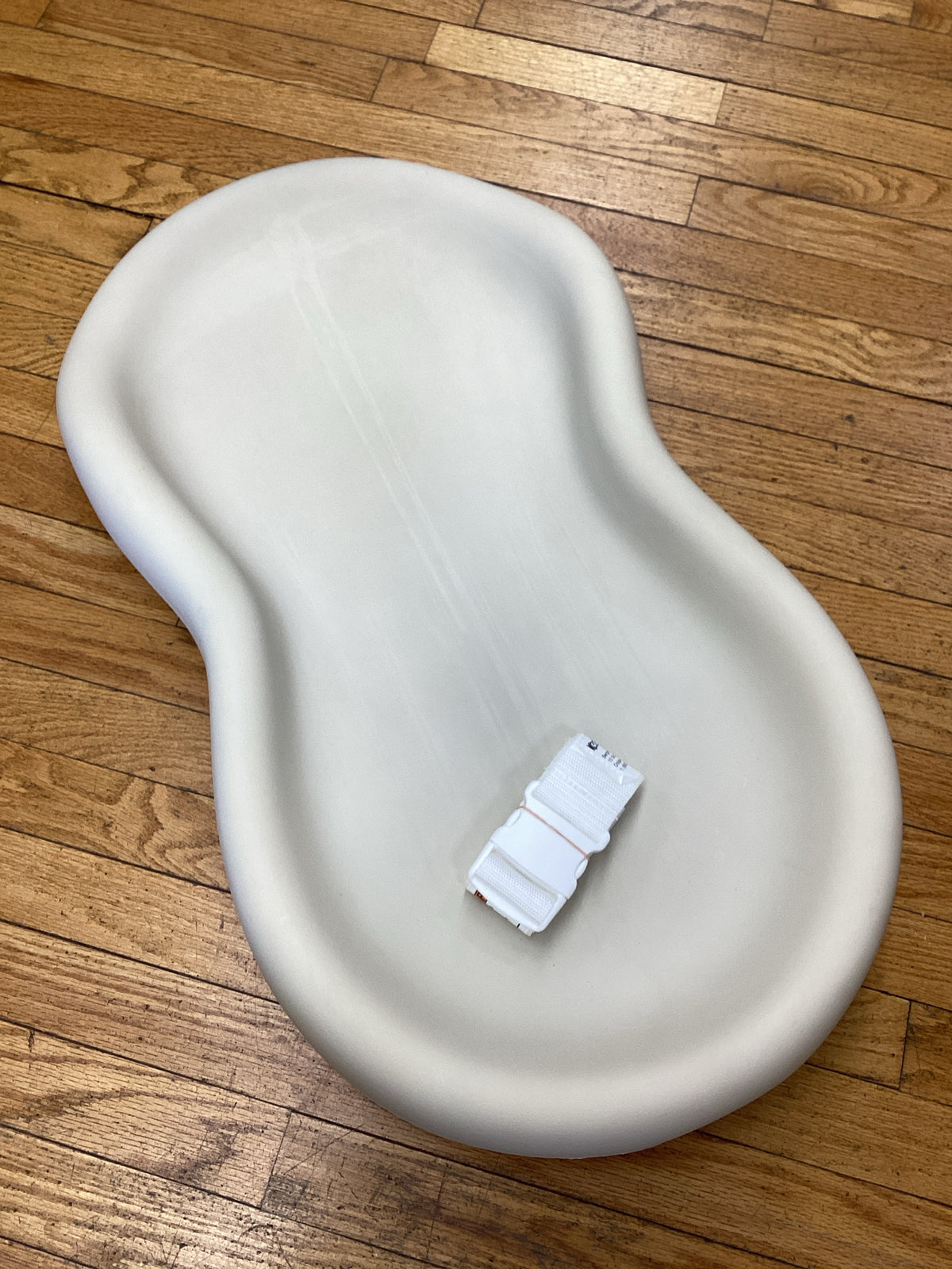 The Peanut Shell Tan Changing Pad with strap
